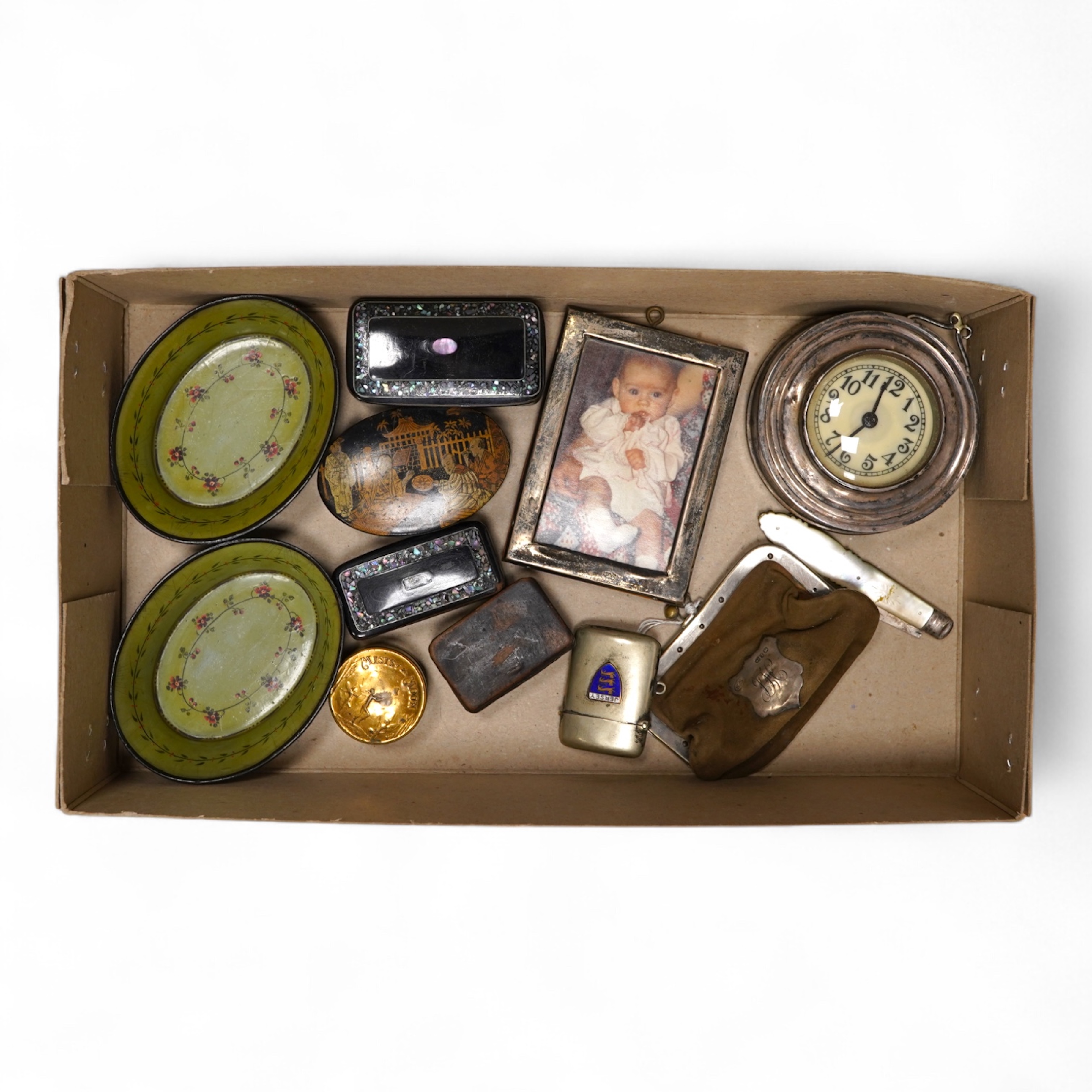 A collection of objects of vertu including snuff boxes, a pair of miniature oval trays, a silver mounted clock and photo frame, etc.